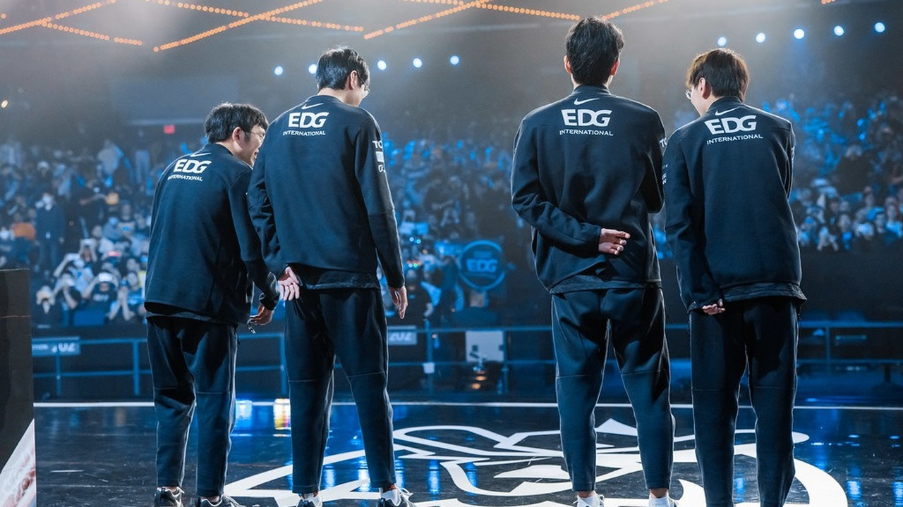 EDward Gaming players stand together on an esports stage