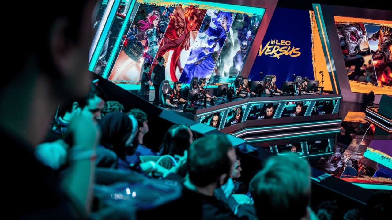 A Shifters League of Legends player greets an opponent on stage